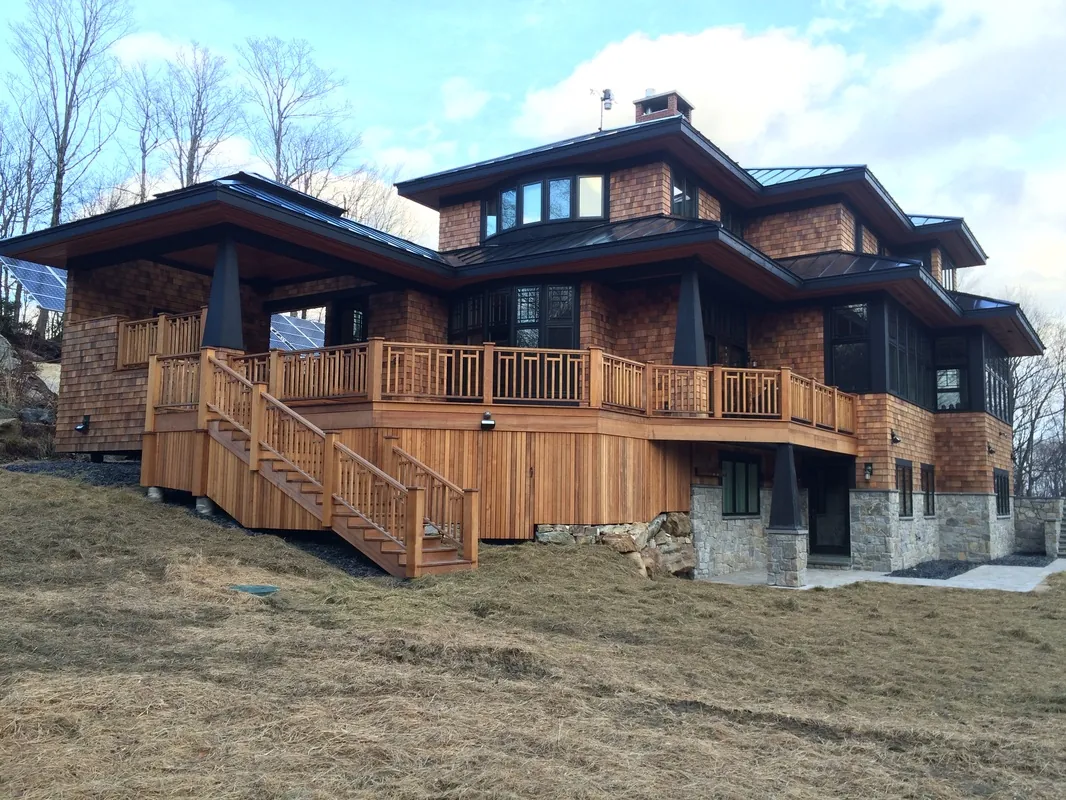 Large modern prairie-style home with wraparound cedar decks