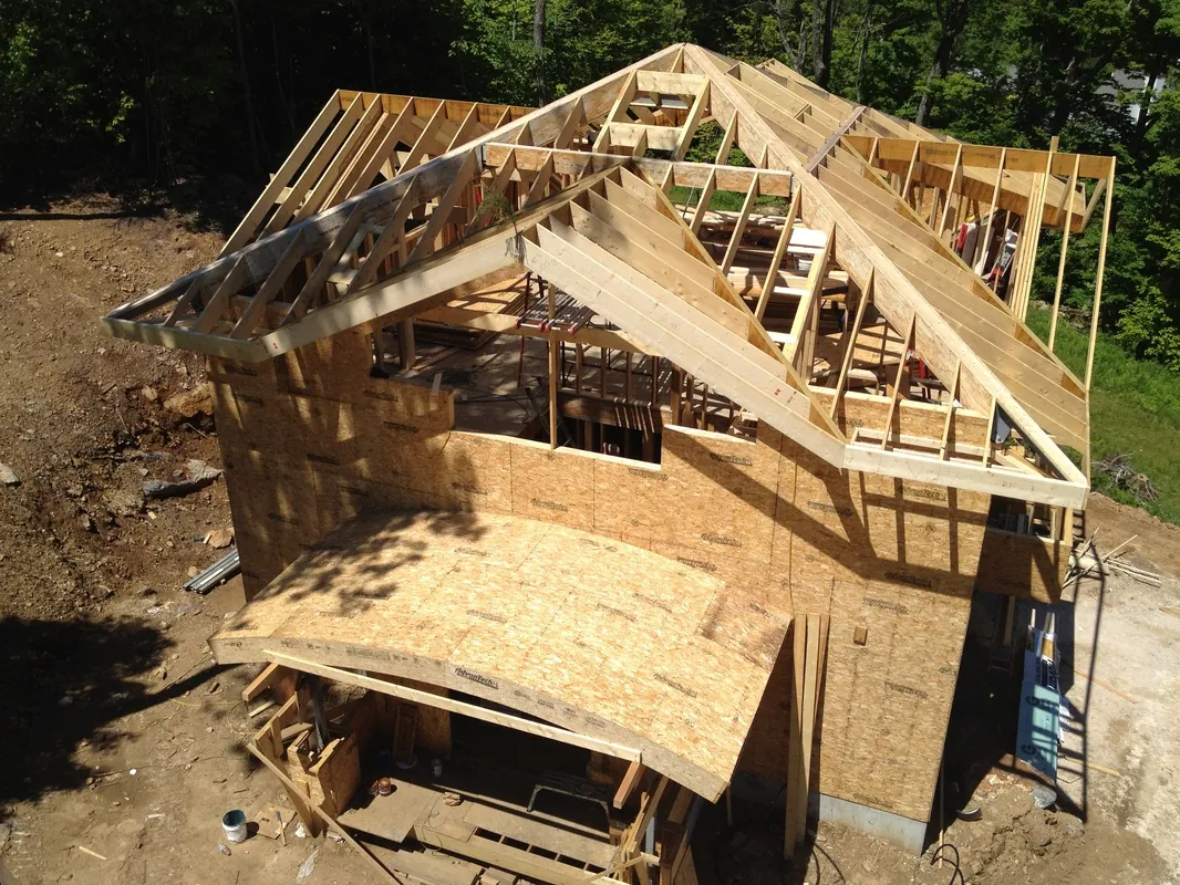 Roof trusses and framing on a wooded site