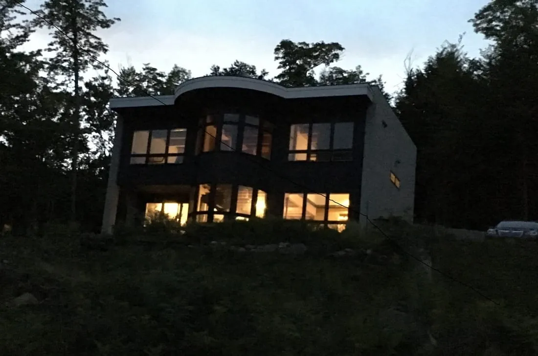 Modern home glowing with interior light at dusk