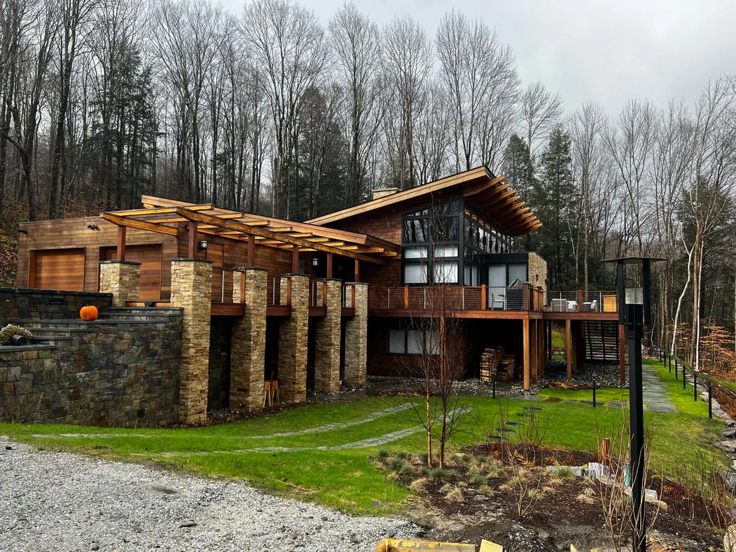 Timber and stone home with pergola-covered terrace