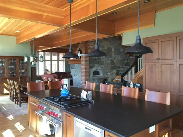 Kitchen with wood ceiling, island seating and pendant lights