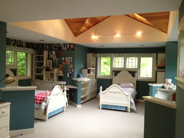 Bedroom with a coffered wood ceiling and built-ins