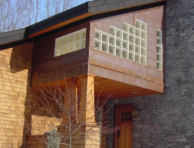 Glass-block bay and stone detail on a shingle home
