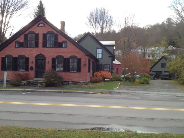 Red gabled village home beside a country road