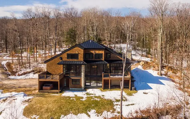 Timber home on a snowy wooded site