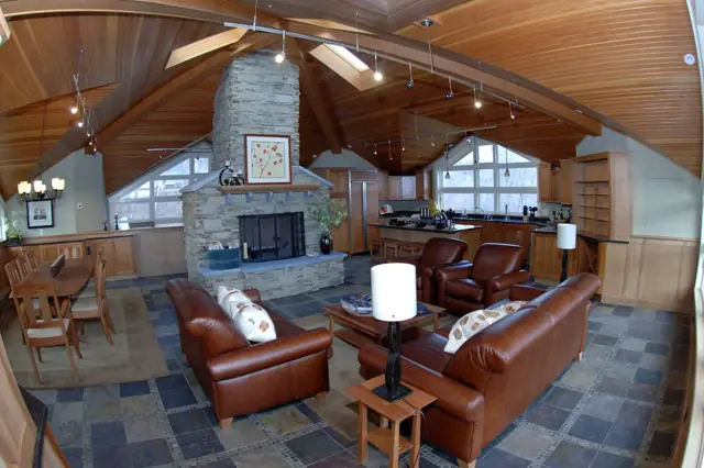 Great room with stone fireplace, wood ceiling and slate floor