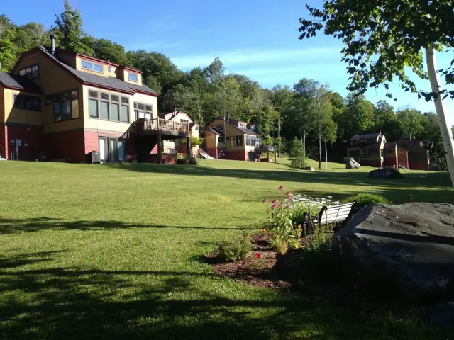 Village homes beyond a green lawn