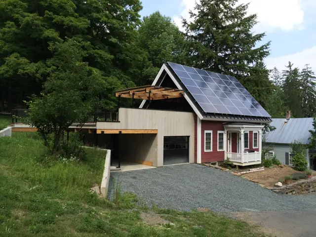 Home and attached garage on a sloped green site