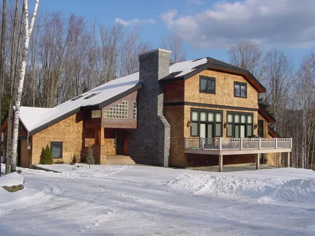 Stone chimney and timber gables on a winter home