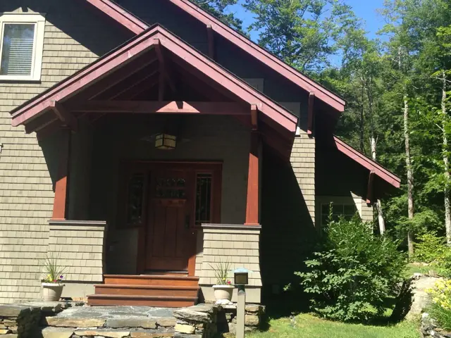 Craftsman entry with timber brackets and shingles