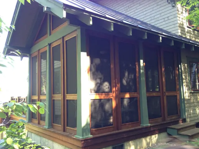 Screened porch with green trim