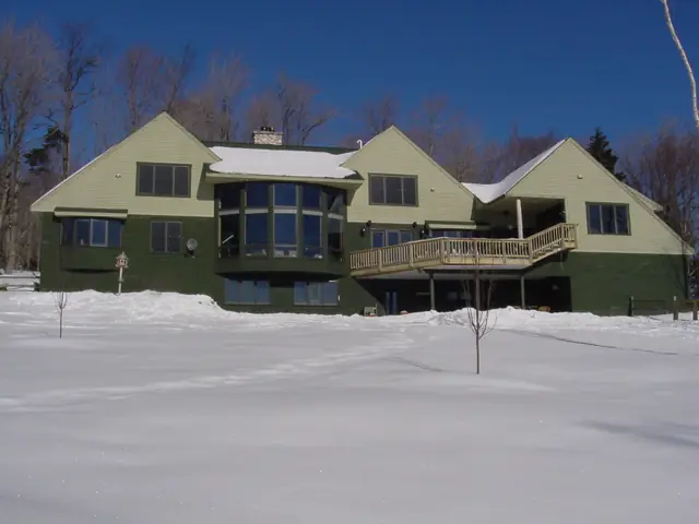 Long gabled home under a clear winter sky