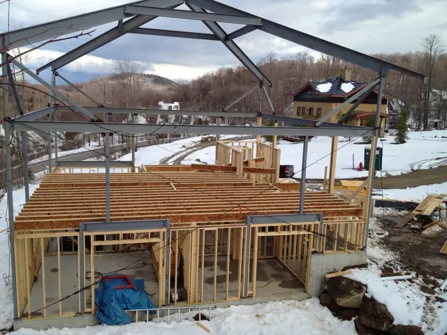Wall and floor framing under way in winter