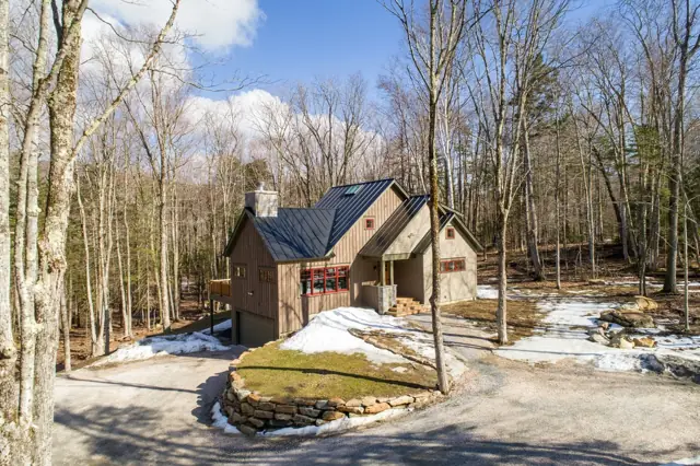 Home among tall trees in early spring