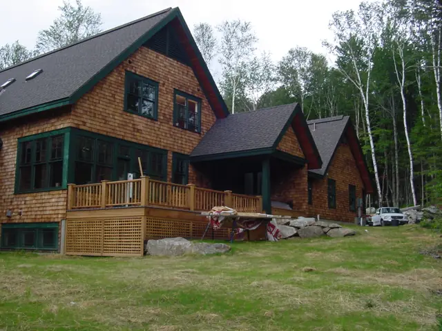 Shingle home with a broad lawn and porch