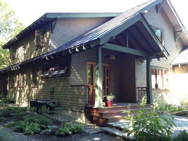 Craftsman home with deep eaves and a planted entry garden